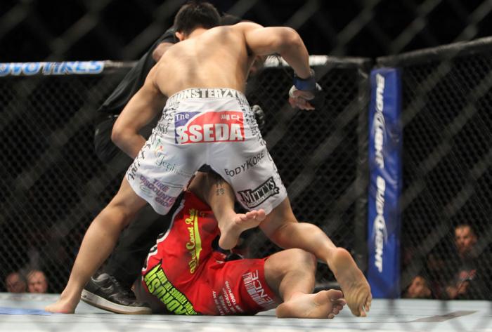 TORONTO, ON - DECEMBER 10: "The Korean Zombie" Chan Sung Jung (white shorts) defeats Mark Hominick by knockout during the UFC 140 event at Air Canada Centre on December 10, 2011 in Toronto, Ontario, Canada. (Photo by Josh Hedges/Zuffa LLC/Zuffa LLC via