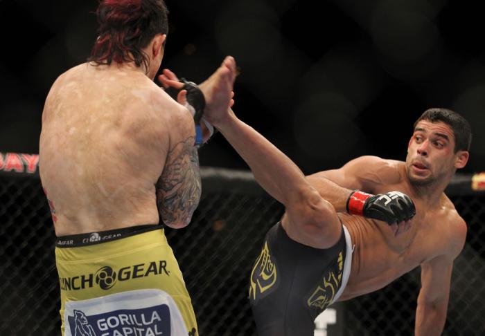 LAS VEGAS, NV - FEBRUARY 04: Renan Barao (right) attempts to kick Scott Jorgensen during the UFC 143 event at Mandalay Bay Events Center on February 4, 2012 in Las Vegas, Nevada. (Photo by Josh Hedges/Zuffa LLC/Zuffa LLC via Getty Images) *** Local Capt