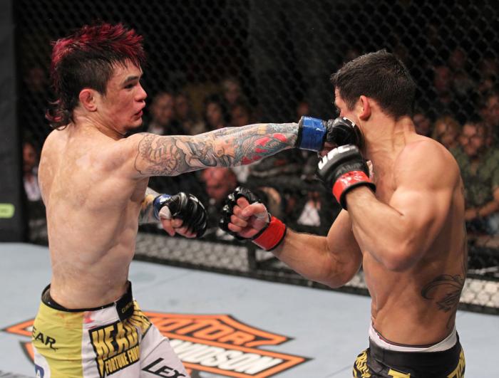 LAS VEGAS, NV - FEBRUARY 04: Scott Jorgensen (left) punches Renan Barao during the UFC 143 event at Mandalay Bay Events Center on February 4, 2012 in Las Vegas, Nevada. (Photo by Nick Laham/Zuffa LLC/Zuffa LLC via Getty Images) *** Local Caption *** Sco