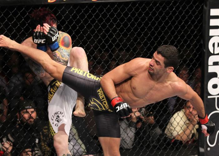 LAS VEGAS, NV - FEBRUARY 04: Renan Barao (right) delivers a roundhouse kick to Scott Jorgensen during the UFC 143 event at Mandalay Bay Events Center on February 4, 2012 in Las Vegas, Nevada. (Photo by Nick Laham/Zuffa LLC/Zuffa LLC via Getty Images) **