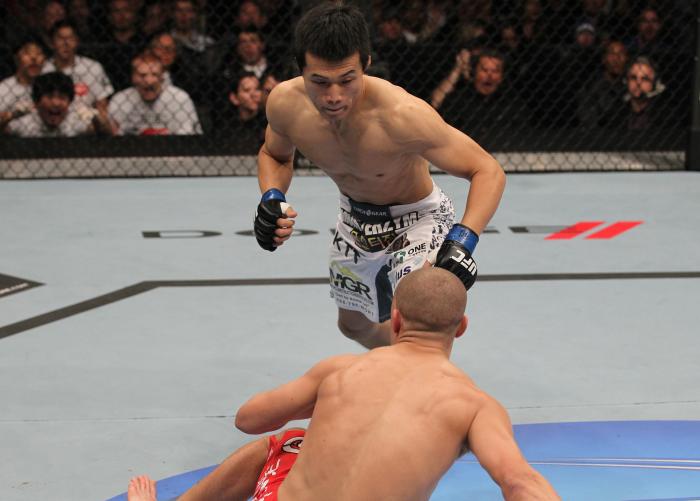 TORONTO, ON - DECEMBER 10: (L-R) "The Korean Zombie" Chan Sung Jung rushes in to finish Mark Hominick after knocking him down with a punch during the UFC 140 event at Air Canada Centre on December 10, 2011 in Toronto, Ontario, Canada. (Photo by Nick Lah