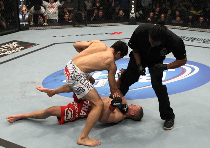 TORONTO, ON - DECEMBER 10: (L-R) "The Korean Zombie" Chan Sung Jung defeats Mark Hominick by knockout during the UFC 140 event at Air Canada Centre on December 10, 2011 in Toronto, Ontario, Canada. (Photo by Nick Laham/Zuffa LLC/Zuffa LLC via Getty Imag
