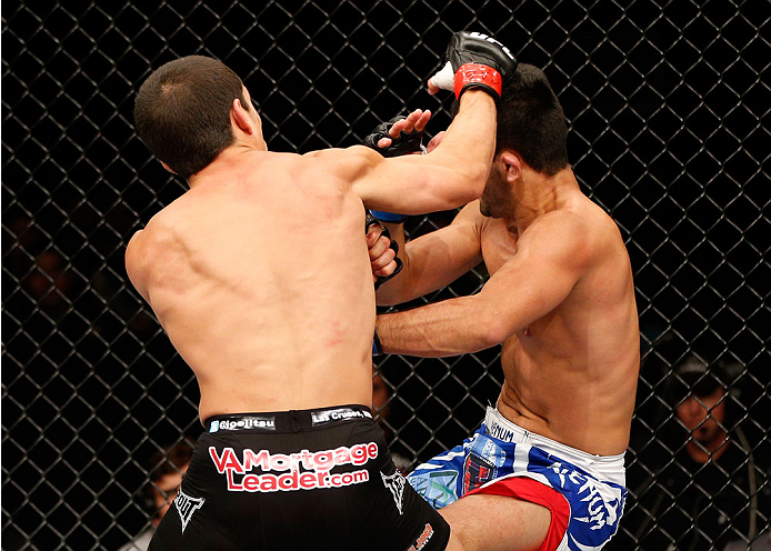 BELO HORIZONTE, BRAZIL - SEPTEMBER 04: (L-R) Joseph Benavidez knocks down Jussier Formiga with a punch in the flyweight fight during the UFC on FOX Sports 1 event at Mineirinho Arena on September 4, 2013 in Belo Horizonte, Brazil. (Photo by Josh Hedges/Z