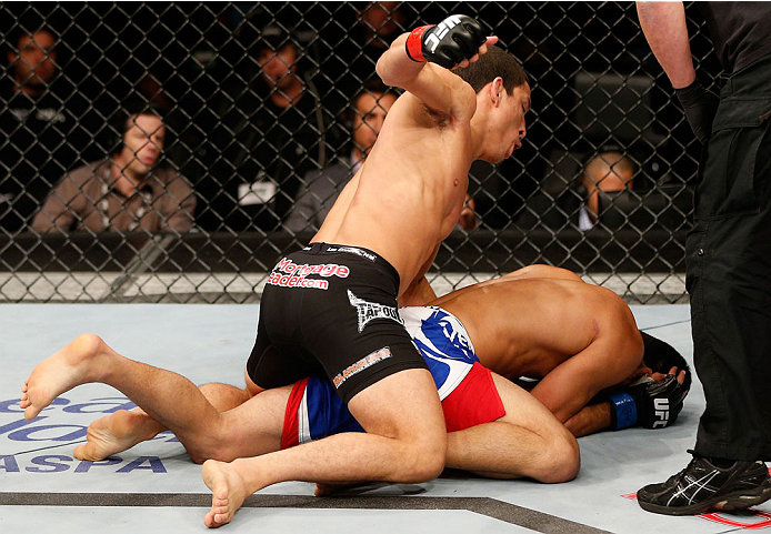BELO HORIZONTE, BRAZIL - SEPTEMBER 04: (L-R) Joseph Benavidez defeats Jussier Formiga by TKO in the flyweight fight during the UFC on FOX Sports 1 event at Mineirinho Arena on September 4, 2013 in Belo Horizonte, Brazil. (Photo by Josh Hedges/Zuffa LLC/Z