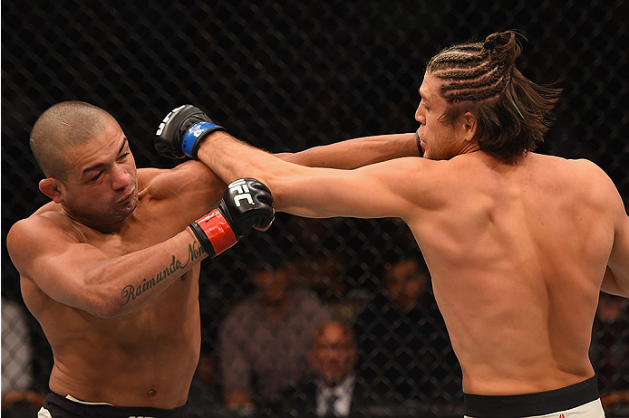 LAS VEGAS, NV - JANUARY 02: (L-R) Diego Brandao of Brazil punches Brian Ortega in their featherweight bout during the UFC 195 event inside MGM Grand Garden Arena on January 2, 2016 in Las Vegas, Nevada. (Photo by Josh Hedges/Zuffa LLC/Zuffa LLC via Getty