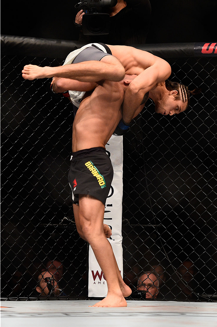 LAS VEGAS, NV - JANUARY 02: Diego Brandao of Brazil (bottom) lifts up Brian Ortega in their featherweight bout during the UFC 195 event inside MGM Grand Garden Arena on January 2, 2016 in Las Vegas, Nevada. (Photo by Jeff Bottari/Zuffa LLC/Zuffa LLC via