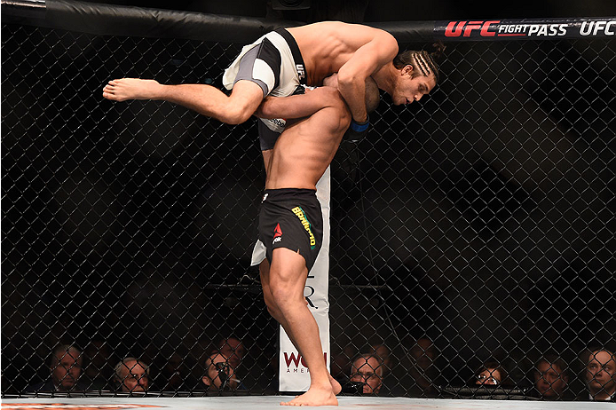 LAS VEGAS, NV - JANUARY 02: Diego Brandao of Brazil (bottom) lifts up Brian Ortega in their featherweight bout during the UFC 195 event inside MGM Grand Garden Arena on January 2, 2016 in Las Vegas, Nevada. (Photo by Jeff Bottari/Zuffa LLC/Zuffa LLC via