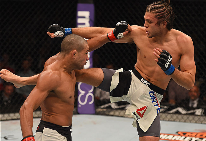LAS VEGAS, NV - JANUARY 02: (R-L) Brian Ortega kicks Diego Brandao of Brazil in their featherweight bout during the UFC 195 event inside MGM Grand Garden Arena on January 2, 2016 in Las Vegas, Nevada. (Photo by Josh Hedges/Zuffa LLC/Zuffa LLC via Getty I