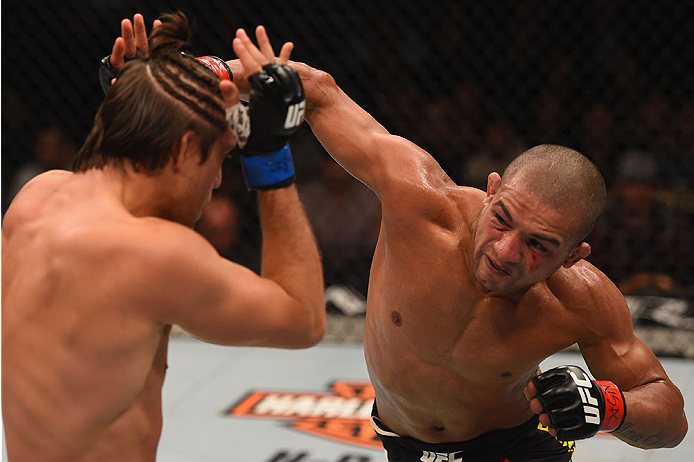 LAS VEGAS, NV - JANUARY 02: (R-L) Diego Brandao of Brazil punches Brian Ortega in their featherweight bout during the UFC 195 event inside MGM Grand Garden Arena on January 2, 2016 in Las Vegas, Nevada. (Photo by Josh Hedges/Zuffa LLC/Zuffa LLC via Getty