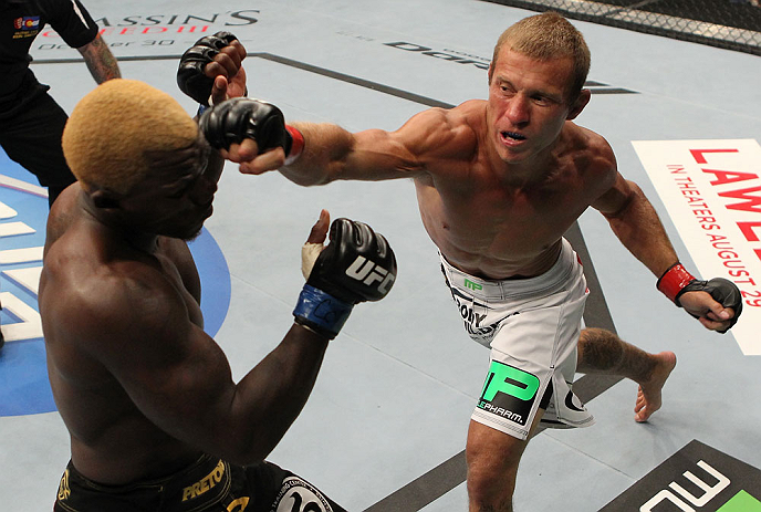 DENVER, CO - AUGUST 11: (R-L) Donald "Cowboy" Cerrone knocks out Melvin Guillard with a punch during their lightweight bout at UFC 150 inside Pepsi Center on August 11, 2012 in Denver, Colorado. (Photo by Josh Hedges/Zuffa LLC/Zuffa LLC via Getty Images)