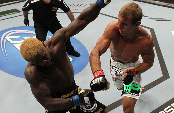 DENVER, CO - AUGUST 11: (R-L) Donald "Cowboy" Cerrone knocks out Melvin Guillard with a punch during their lightweight bout at UFC 150 inside Pepsi Center on August 11, 2012 in Denver, Colorado. (Photo by Josh Hedges/Zuffa LLC/Zuffa LLC via Getty Images)
