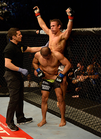 ANAHEIM, CA - FEBRUARY 23: Urijah Faber (top) reacts to his submission victory over Ivan Menjivar (bottom) in their bantamweight bout during UFC 157 at Honda Center on February 23, 2013 in Anaheim, California. (Photo by Donald Miralle/Zuffa LLC/Zuffa LL