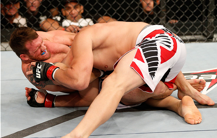 BELO HORIZONTE, BRAZIL - SEPTEMBER 04: (L-R) Ryan Bader attempts a guillotine choke submission against Glover Teixeira in their light heavyweight fight during the UFC on FOX Sports 1 event at Mineirinho Arena on September 4, 2013 in Belo Horizonte, Brazi