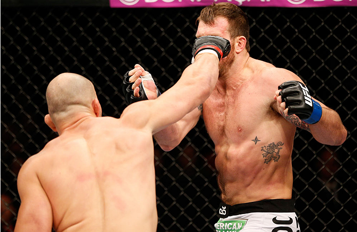 BELO HORIZONTE, BRAZIL - SEPTEMBER 04: (L-R) Glover Teixeira punches Ryan Bader in their light heavyweight fight during the UFC on FOX Sports 1 event at Mineirinho Arena on September 4, 2013 in Belo Horizonte, Brazil. (Photo by Josh Hedges/Zuffa LLC/Zuff