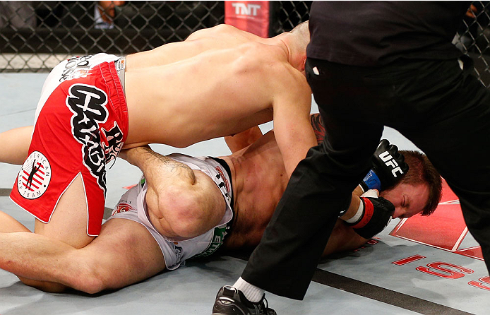 BELO HORIZONTE, BRAZIL - SEPTEMBER 04: (L-R) Glover Teixeira punches Ryan Bader in their light heavyweight fight during the UFC on FOX Sports 1 event at Mineirinho Arena on September 4, 2013 in Belo Horizonte, Brazil. (Photo by Josh Hedges/Zuffa LLC/Zuff