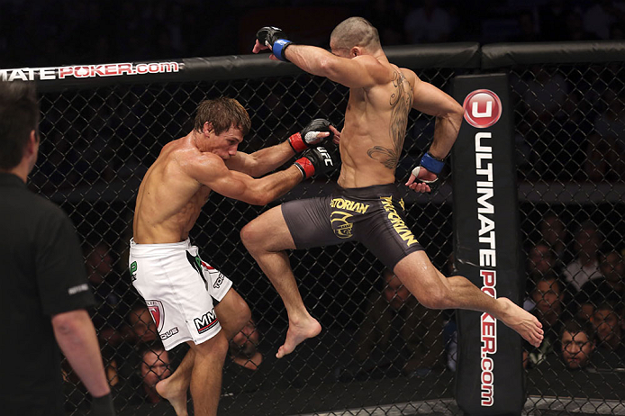 CALGARY, CANADA - JULY 21: (R-L) Renan Barao leaps toward Urijah Faber during their UFC interim bantamweight championship bout at UFC 149 inside the Scotiabank Saddledome on July 21, 2012 in Calgary, Alberta, Canada. (Photo by Nick Laham/Zuffa LLC/Zuffa