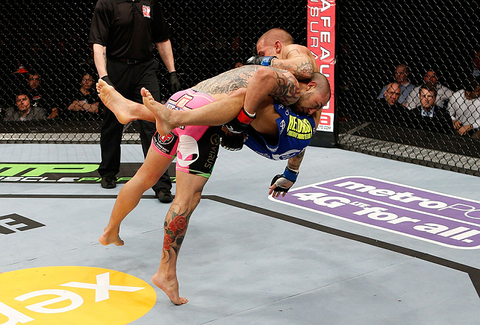 LONDON, ENGLAND - FEBRUARY 16: (L-R) Cub Swanson takes down Dustin Poirier in their featherweight fight during the UFC on Fuel TV event on February 16, 2013 at Wembley Arena in London, England. (Photo by Josh Hedges/Zuffa LLC/Zuffa LLC via Getty Images)