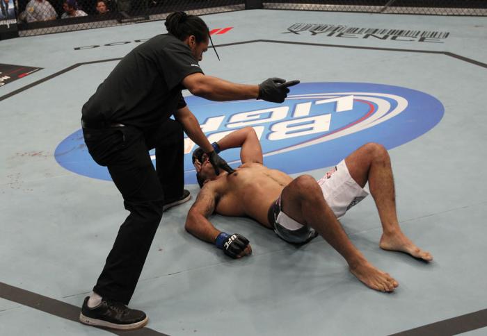 TORONTO, ON - DECEMBER 10: (L-R) Referee Herb Dean calls for a doctor after Antonio Rodrigo Nogueira suffered a separated shoulder from an arm lock against Frank Mir during the UFC 140 event at Air Canada Centre on December 10, 2011 in Toronto, Ontario,