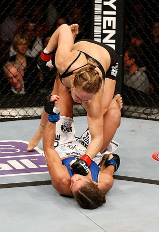 ANAHEIM, CA - FEBRUARY 23: Ronda Rousey (top) punches Liz Carmouche in their women's bantamweight title fight during UFC 157 at Honda Center on February 23, 2013 in Anaheim, California. (Photo by Josh Hedges/Zuffa LLC/Zuffa LLC via Getty Images) *** Loc