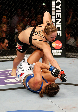 ANAHEIM, CA - FEBRUARY 23: Ronda Rousey (top) punches Liz Carmouche in their women's bantamweight title fight during UFC 157 at Honda Center on February 23, 2013 in Anaheim, California. (Photo by Josh Hedges/Zuffa LLC/Zuffa LLC via Getty Images) *** Loc