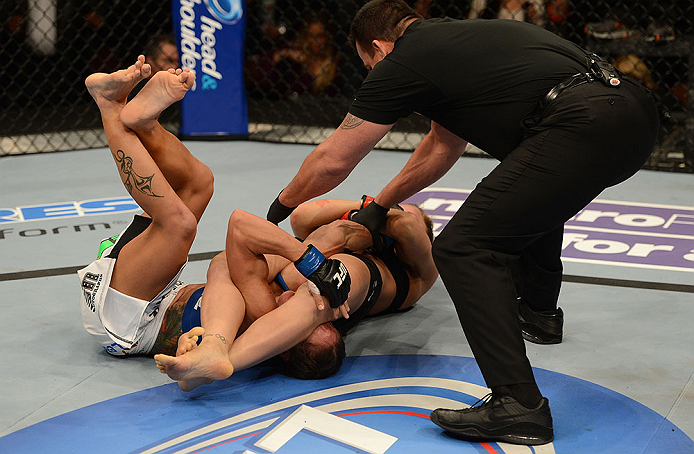 ANAHEIM, CA - FEBRUARY 23: Ronda Rousey (center) attempts to submit Liz Carmouche in their women's bantamweight title fight during UFC 157 at Honda Center on February 23, 2013 in Anaheim, California. (Photo by Donald Miralle/Zuffa LLC/Zuffa LLC via Gett