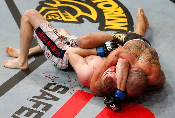 LONDON, ENGLAND - FEBRUARY 16: (R-L) Renan Barao secures an arm triangle choke submission to defeat Michael McDonald in their interim bantamweight title fight during the UFC on Fuel TV event on February 16, 2013 at Wembley Arena in London, England. (Pho