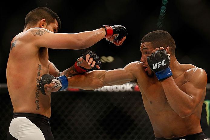 LAS VEGAS, NV - APRIL 23: (R-L) Kevin Lee punches Efrain Escudero of Mexico in their lightweight bout during the UFC 197 event inside MGM Grand Garden Arena on April 23, 2016 in Las Vegas, Nevada. (Photo by Christian Petersen/Zuffa LLC/Zuffa LLC via Get