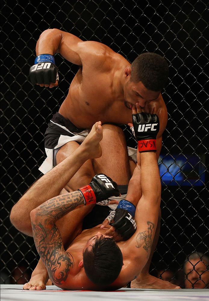 LAS VEGAS, NV - APRIL 23: Kevin Lee (top) punches Efrain Escudero of Mexico in their lightweight bout during the UFC 197 event inside MGM Grand Garden Arena on April 23, 2016 in Las Vegas, Nevada. (Photo by Christian Petersen/Zuffa LLC/Zuffa LLC via Get