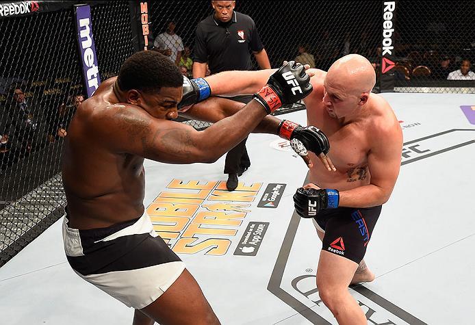 LAS VEGAS, NV - APRIL 23: (R-L) Cody East punches Walt Harris in their heavyweight bout during the UFC 197 event inside MGM Grand Garden Arena on April 23, 2016 in Las Vegas, Nevada. (Photo by Josh Hedges/Zuffa LLC/Zuffa LLC via Getty Images)