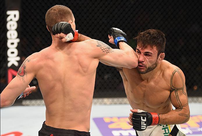 LAS VEGAS, NV - APRIL 23: (R-L) Glaico Franca of Brazil exchange punches with James Vick in their lightweight bout during the UFC 197 event inside MGM Grand Garden Arena on April 23, 2016 in Las Vegas, Nevada. (Photo by Josh Hedges/Zuffa LLC/Zuffa LLC v