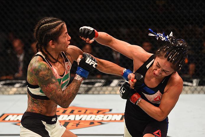 LAS VEGAS, NV - APRIL 23: (R-L) Carla Esparza exchanges punches with Juliana Lima in their women's strawweight bout during the UFC 197 event inside MGM Grand Garden Arena on April 23, 2016 in Las Vegas, Nevada. (Photo by Josh Hedges/Zuffa LLC/Zuffa LLC
