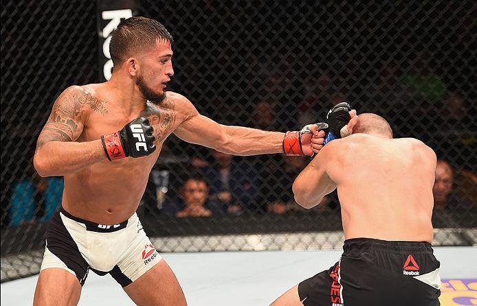 LAS VEGAS, NV - APRIL 23: (L-R) Sergio Pettis punches Chris Kelades in their flyweight bout during the UFC 197 event inside MGM Grand Garden Arena on April 23, 2016 in Las Vegas, Nevada. (Photo by Josh Hedges/Zuffa LLC/Zuffa LLC via Getty Images)