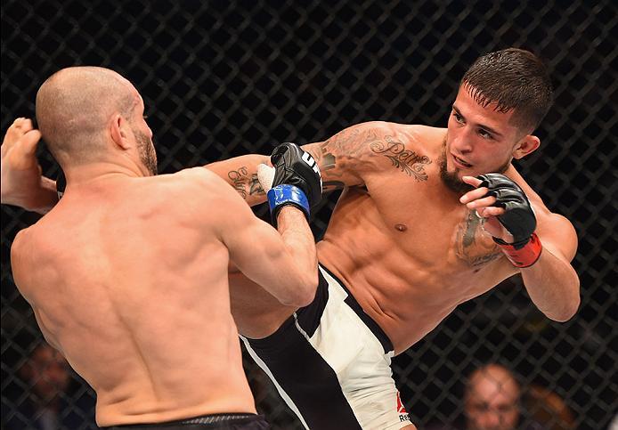 LAS VEGAS, NV - APRIL 23: (R-L) Sergio Pettis kicks Chris Kelades in their flyweight bout during the UFC 197 event inside MGM Grand Garden Arena on April 23, 2016 in Las Vegas, Nevada. (Photo by Josh Hedges/Zuffa LLC/Zuffa LLC via Getty Images)