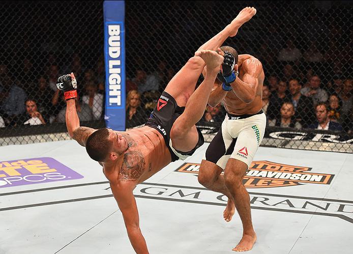 LAS VEGAS, NV - APRIL 23: (L-R) Anthony Pettis kicks Edson Barboza in their lightweight bout during the UFC 197 event inside MGM Grand Garden Arena on April 23, 2016 in Las Vegas, Nevada. (Photo by Josh Hedges/Zuffa LLC/Zuffa LLC via Getty Images)