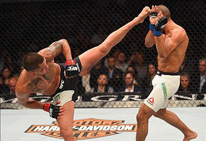 LAS VEGAS, NV - APRIL 23: (L-R) Anthony Pettis kicks Edson Barboza in their lightweight bout during the UFC 197 event inside MGM Grand Garden Arena on April 23, 2016 in Las Vegas, Nevada. (Photo by Josh Hedges/Zuffa LLC/Zuffa LLC via Getty Images)