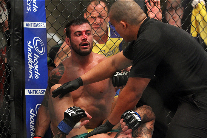 SAO PAULO, BRAZIL - JANUARY 24: Team Wanderlei fighter Ricardo Abreu is stopped by the referee after defeating Team Sonnen fighter Guilherme de Vasconcelos in their middleweight fight during season three of The Ultimate Fighter Brazil on January 24, 2014