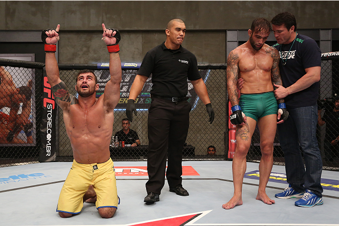 SAO PAULO, BRAZIL - JANUARY 24: (L-R) Team Wanderlei fighter Ricardo Abreu celebrates after defeating Team Sonnen fighter Guilherme de Vasconcelos as coach Chael Sonnen consoles Vasconcelos in their middleweight fight during season three of The Ultimate