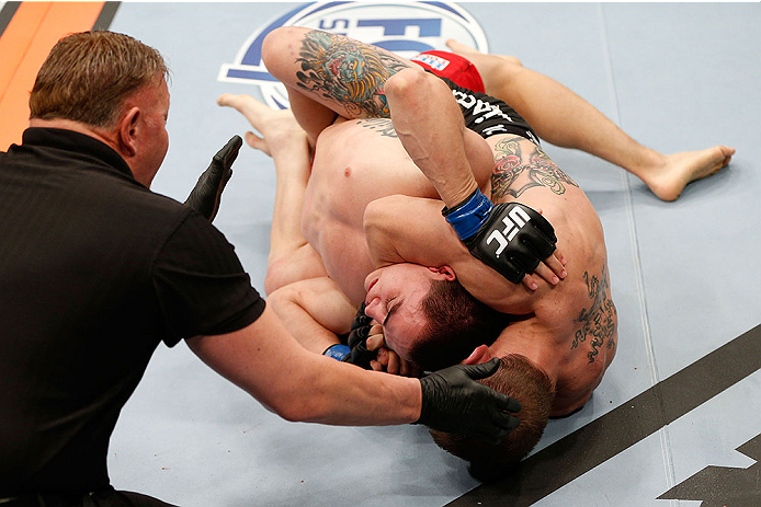 LAS VEGAS, NV - NOVEMBER 30: (R-L) Josh Sampo submits Ryan Benoit by rear naked choke in their flyweight fight during The Ultimate Fighter season 18 live finale inside the Mandalay Bay Events Center on November 30, 2013 in Las Vegas, Nevada. (Photo by Jo