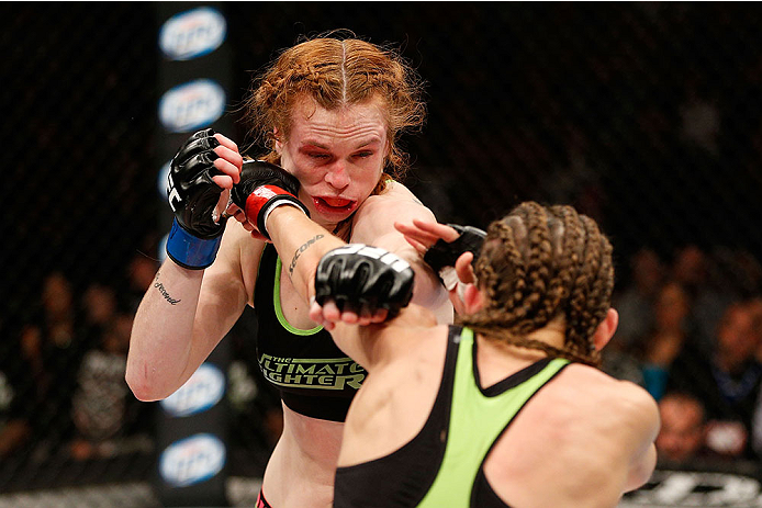 LAS VEGAS, NV - NOVEMBER 30: (R-L) Jessamyn Duke punches Peggy Morgan in their women's bantamweight fight during The Ultimate Fighter season 18 live finale inside the Mandalay Bay Events Center on November 30, 2013 in Las Vegas, Nevada. (Photo by Josh He