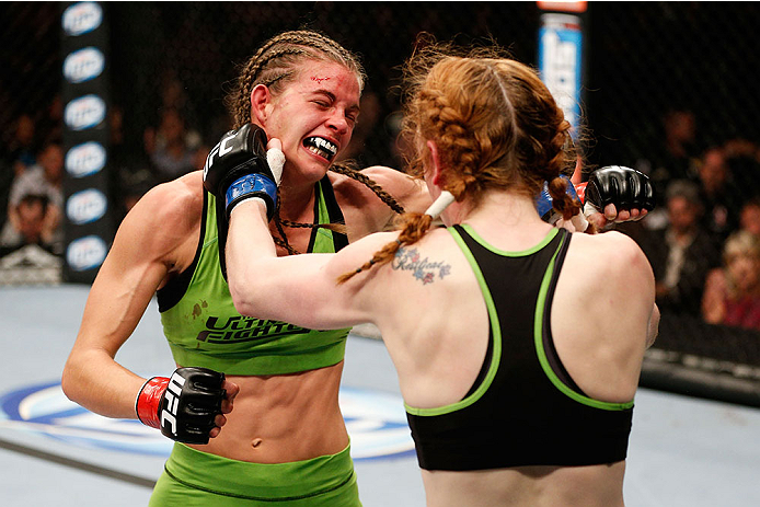 LAS VEGAS, NV - NOVEMBER 30: (L-R) Jessamyn Duke exchanges punches with Peggy Morgan in their women's bantamweight fight during The Ultimate Fighter season 18 live finale inside the Mandalay Bay Events Center on November 30, 2013 in Las Vegas, Nevada. (P