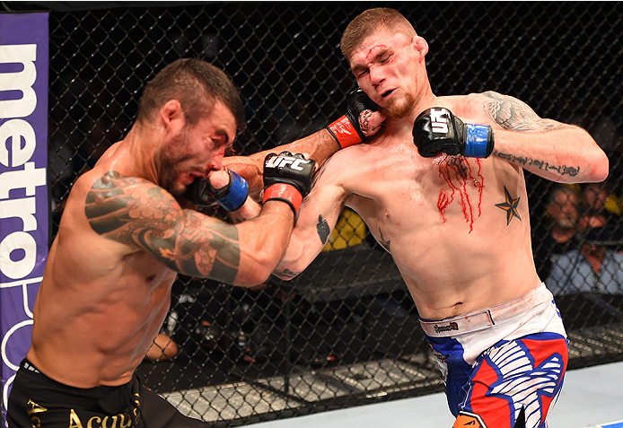 NEW ORLEANS, LA - JUNE 06: (L-R) Ricardo Abreu exchanges punches with Jake Collier in their middleweight bout during the UFC event at the Smoothie King Center on June 6, 2015 in New Orleans, Louisiana. (Photo by Josh Hedges/Zuffa LLC/Zuffa LLC via Getty