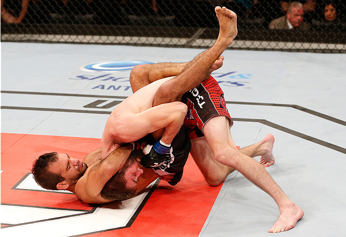 BRASILIA, BRAZIL - SEPTEMBER 13: (L-R) Rani Yahya attempts to secure a guillotine choke against Johnny Bedford in their bantamweight bout during the UFC Fight Night event inside Nilson Nelson Gymnasium on September 13, 2014 in Brasilia, Brazil. (Photo b