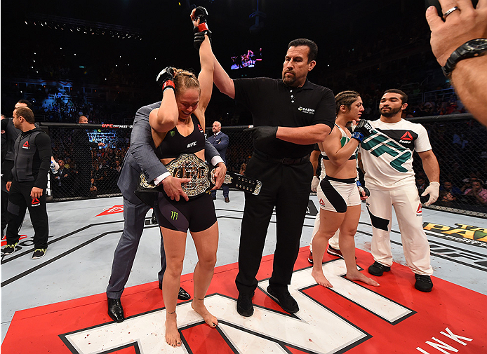 RIO DE JANEIRO, BRAZIL - AUGUST 01: (L-R) Ronda Rousey of the United States celebrates her knock out victory over Bethe Correia of Brazil in the first round in their UFC women's bantamweight championship bout during the UFC 190 event inside HSBC Arena on