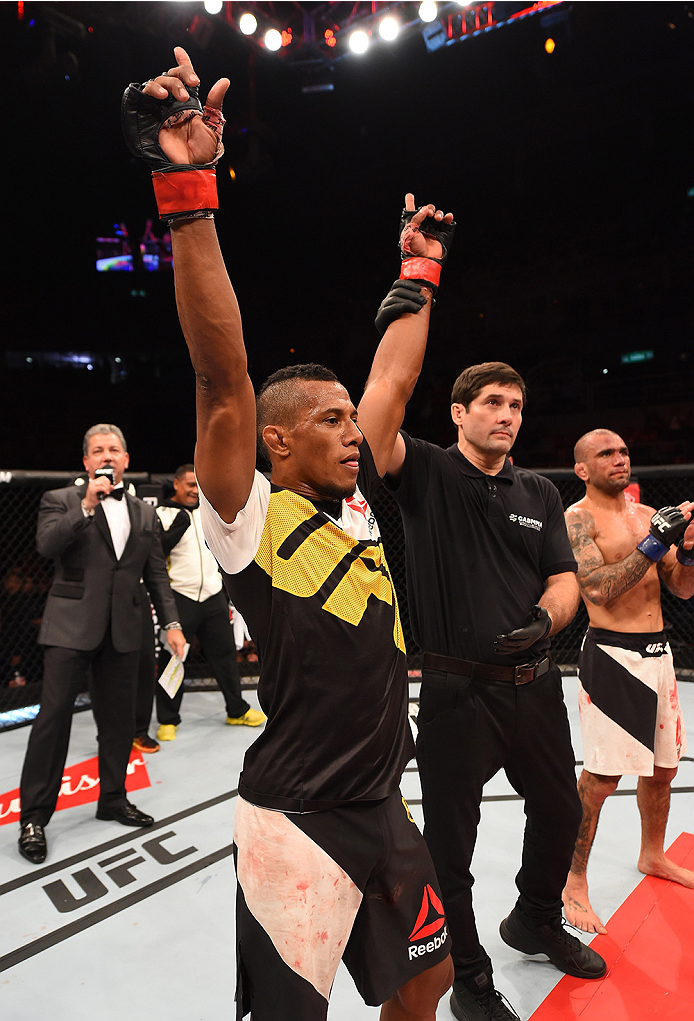 RIO DE JANEIRO, BRAZIL - AUGUST 01: (L-R) Iuri Alcantara of Brazil celebrates his victory over Leandro Issa of Brazil in their bantamweight bout during the UFC 190 event inside HSBC Arena on August 1, 2015 in Rio de Janeiro, Brazil. (Photo by Josh Hedge