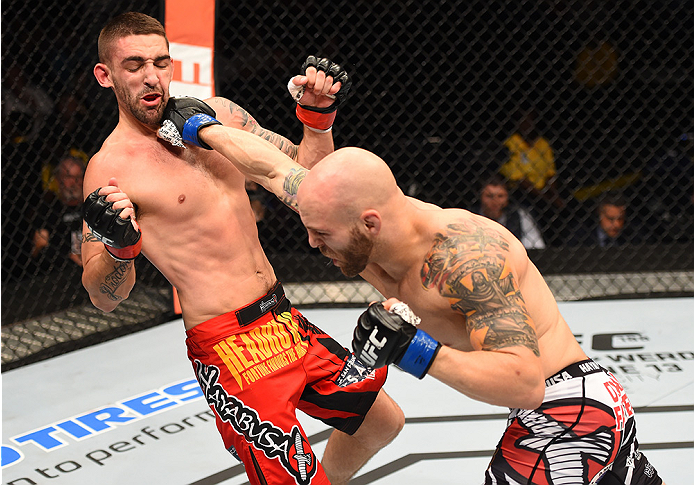 NEW ORLEANS, LA - JUNE 06: (R-L) Justin Edwards punches Joe Proctor in their lightweight bout during the UFC event at the Smoothie King Center on June 6, 2015 in New Orleans, Louisiana. (Photo by Josh Hedges/Zuffa LLC/Zuffa LLC via Getty Images)