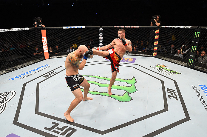 NEW ORLEANS, LA - JUNE 06: (R-L) Joe Proctor kicks Justin Edwards in their lightweight bout during the UFC event at the Smoothie King Center on June 6, 2015 in New Orleans, Louisiana. (Photo by Josh Hedges/Zuffa LLC/Zuffa LLC via Getty Images)