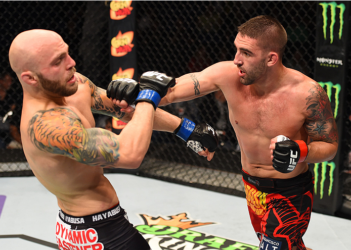 NEW ORLEANS, LA - JUNE 06: (R-L) Joe Proctor punches Justin Edwards in their lightweight bout during the UFC event at the Smoothie King Center on June 6, 2015 in New Orleans, Louisiana. (Photo by Josh Hedges/Zuffa LLC/Zuffa LLC via Getty Images)
