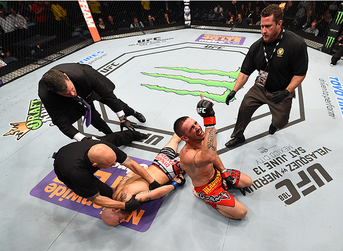 NEW ORLEANS, LA - JUNE 06: (R-L) Joe Proctor celebrates his submission victory over Justin Edwards in their lightweight bout during the UFC event at the Smoothie King Center on June 6, 2015 in New Orleans, Louisiana. (Photo by Josh Hedges/Zuffa LLC/Zuff