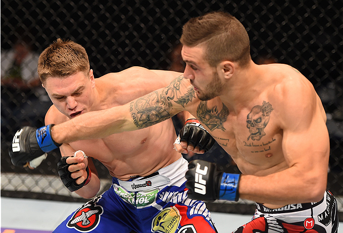 NEW ORLEANS, LA - JUNE 06: (R-L) Christos Giagos punches Chris Wade in their lightweight bout during the UFC event at the Smoothie King Center on June 6, 2015 in New Orleans, Louisiana. (Photo by Josh Hedges/Zuffa LLC/Zuffa LLC via Getty Images)