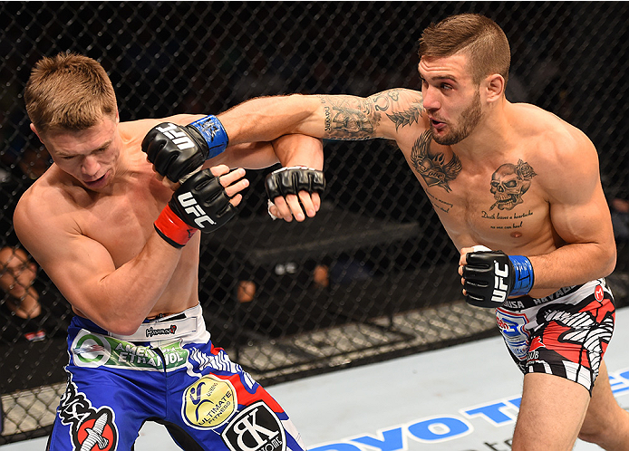 NEW ORLEANS, LA - JUNE 06: (R-L) Christos Giagos punches Chris Wade in their lightweight bout during the UFC event at the Smoothie King Center on June 6, 2015 in New Orleans, Louisiana. (Photo by Josh Hedges/Zuffa LLC/Zuffa LLC via Getty Images)